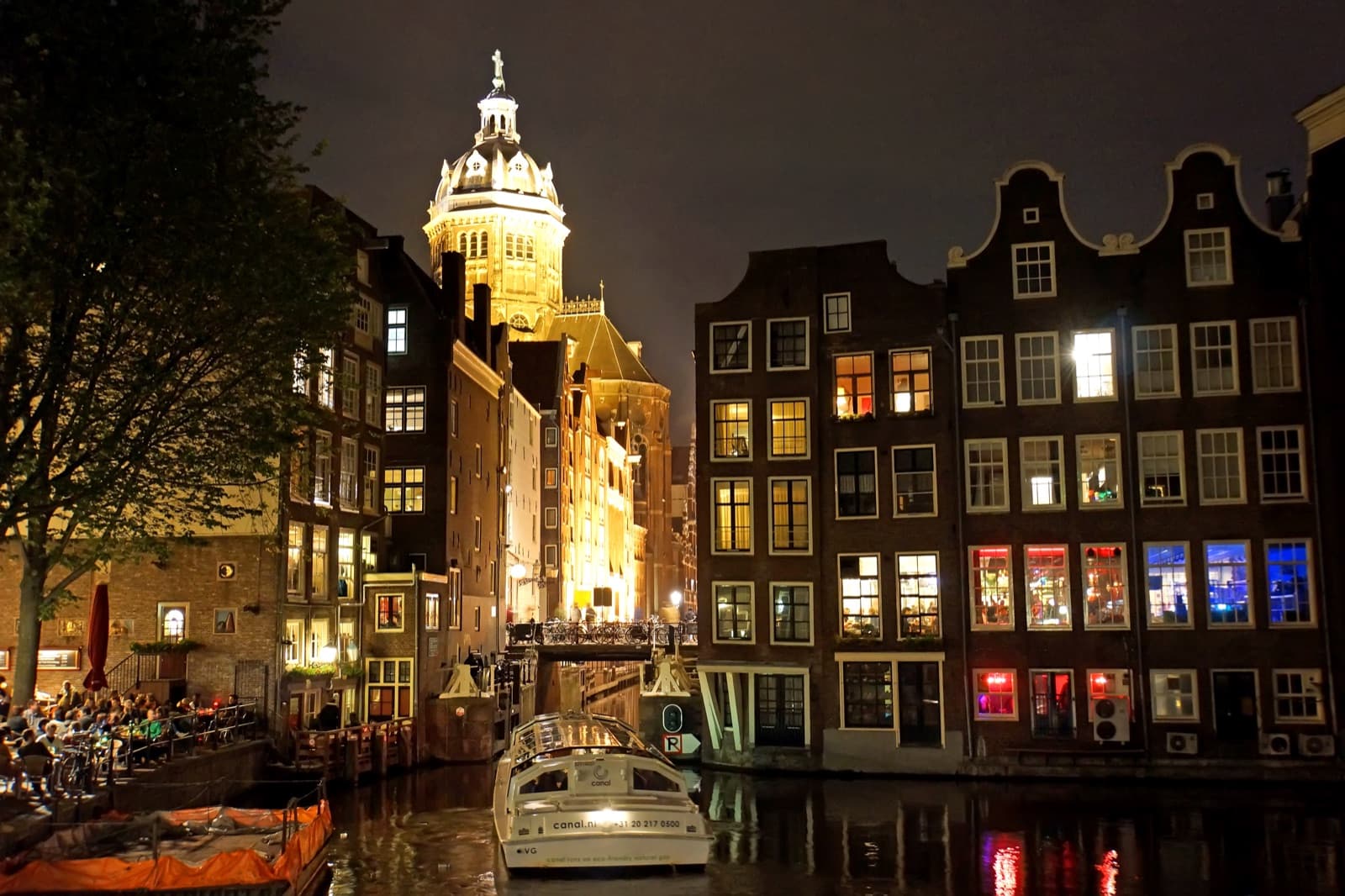 Amsterdam canals at night with soft neon reflections
