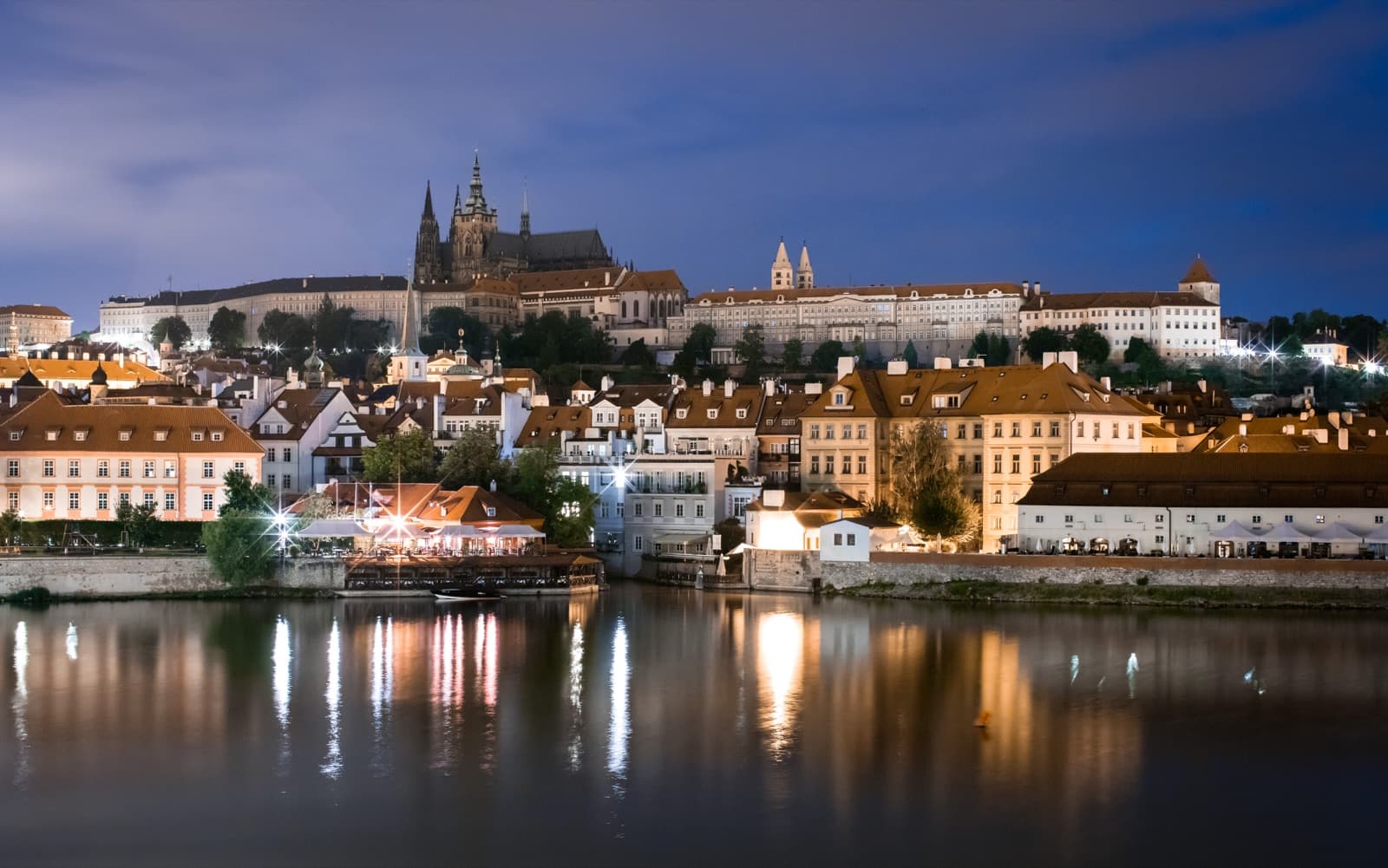 European night travel scene with city lights and a dark premium atmosphere